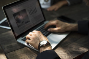 Picture shows male hands working at a computer